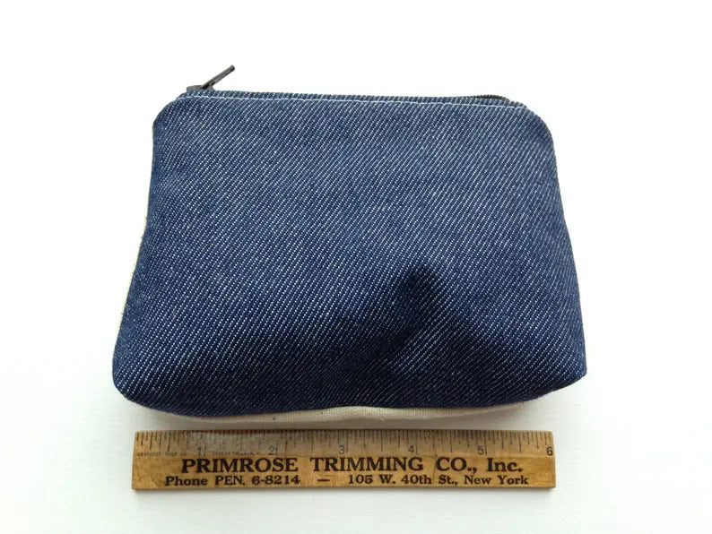 Back denim exterior of hand sewn zippered pouch 