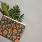 Wristlet zippered pouch with fern leaves in it 