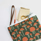 Wristlet zippered pouch with scissors, a pencil and notepad in it 
