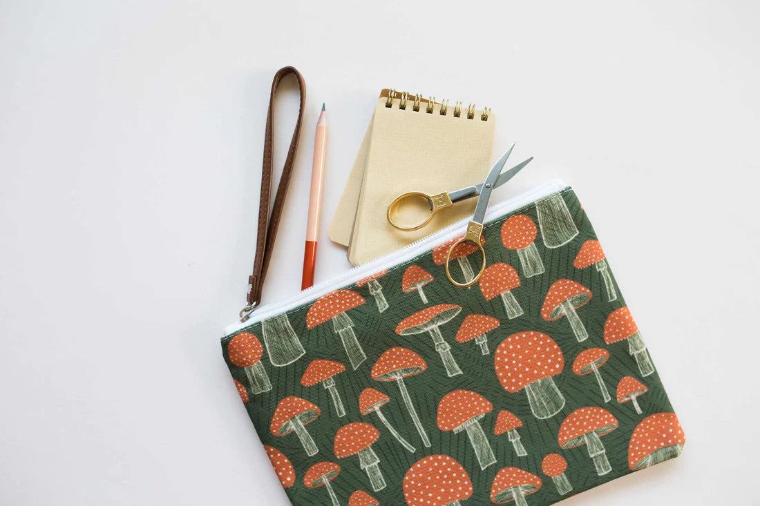 Wristlet zippered pouch with scissors, a pencil and notepad in it 