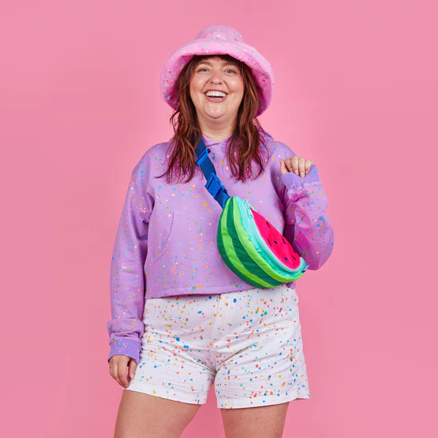 Neon watermelon fanny pack worn as a cross body on model 