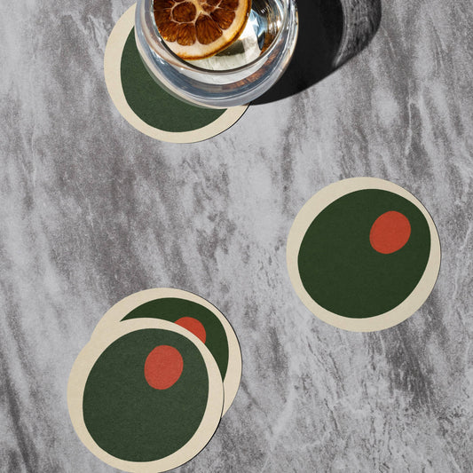 Pimento olive coasters on tabletop with a drink on one of them 