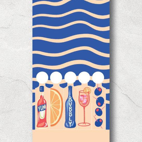 Spritz matchbook open to reaveal that the matches are in the shape of Campari, orange wedge, bubbles, spritz in a glass and olives on a pick.