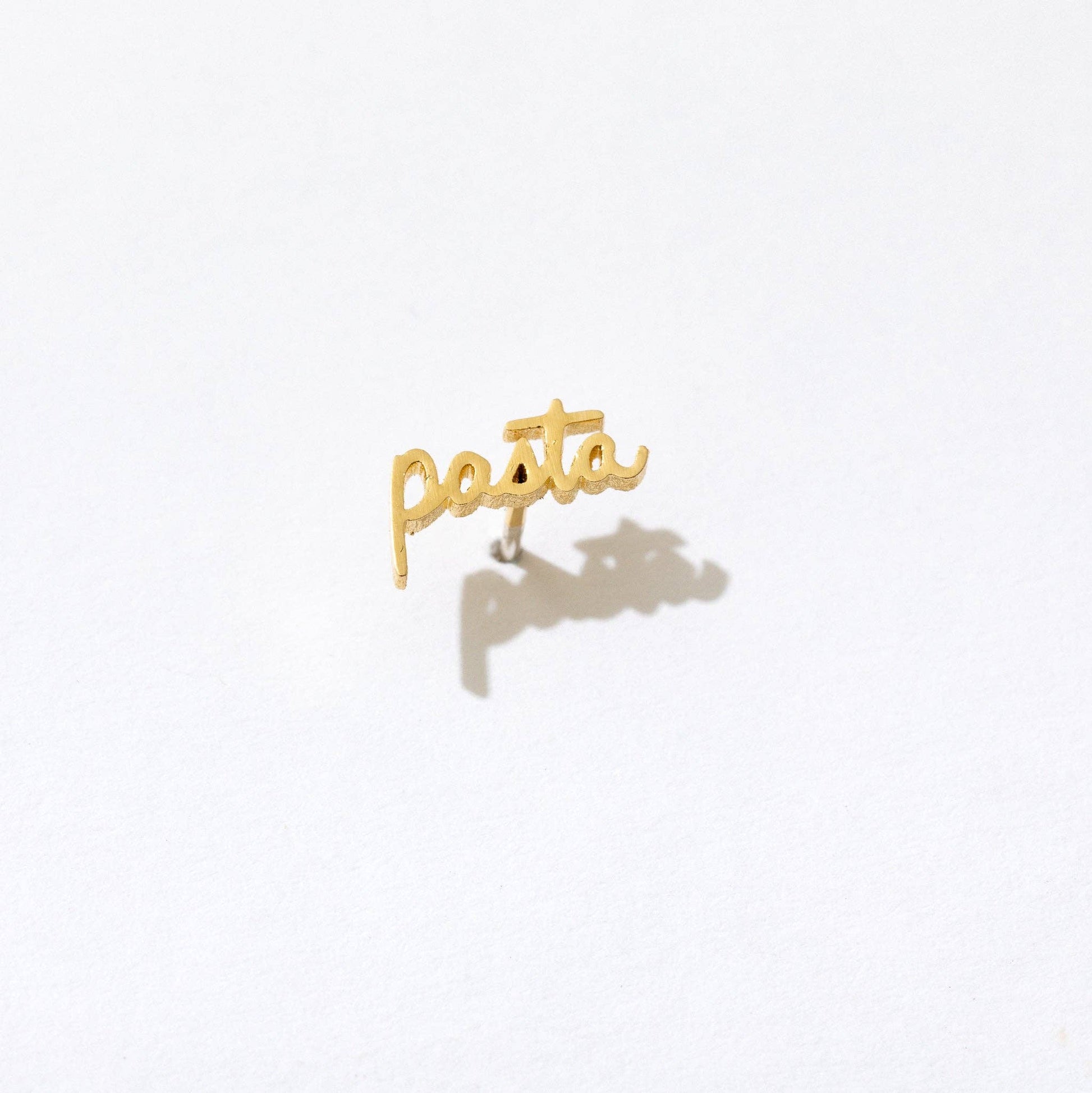 Single 14k gold plated stud earring -- reads "pasta" in handwritten script