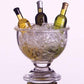 Bottle stopper designed with an acrylic wine bowl filled with ice and 3 wine bottles in it. 