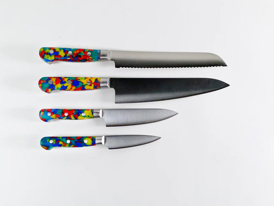 4 different knives all with brightly colored handles that are a mix of yellow, red and blues. 