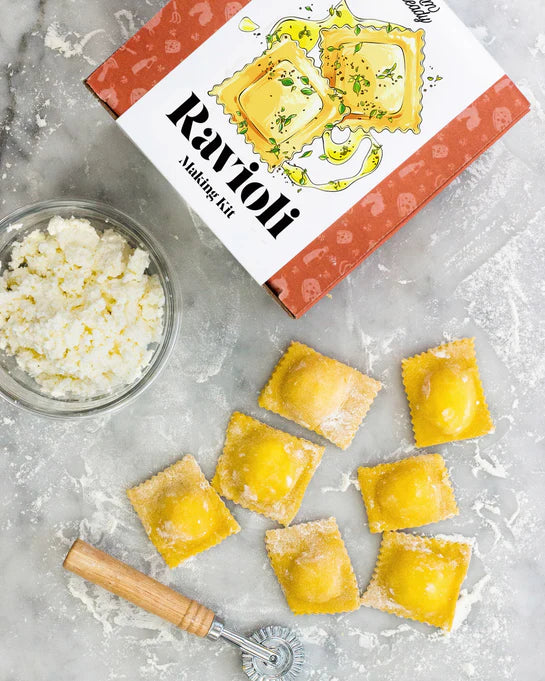 Overhead view of the ravioli making kit, ricotta mixture and freshly made raviolis 