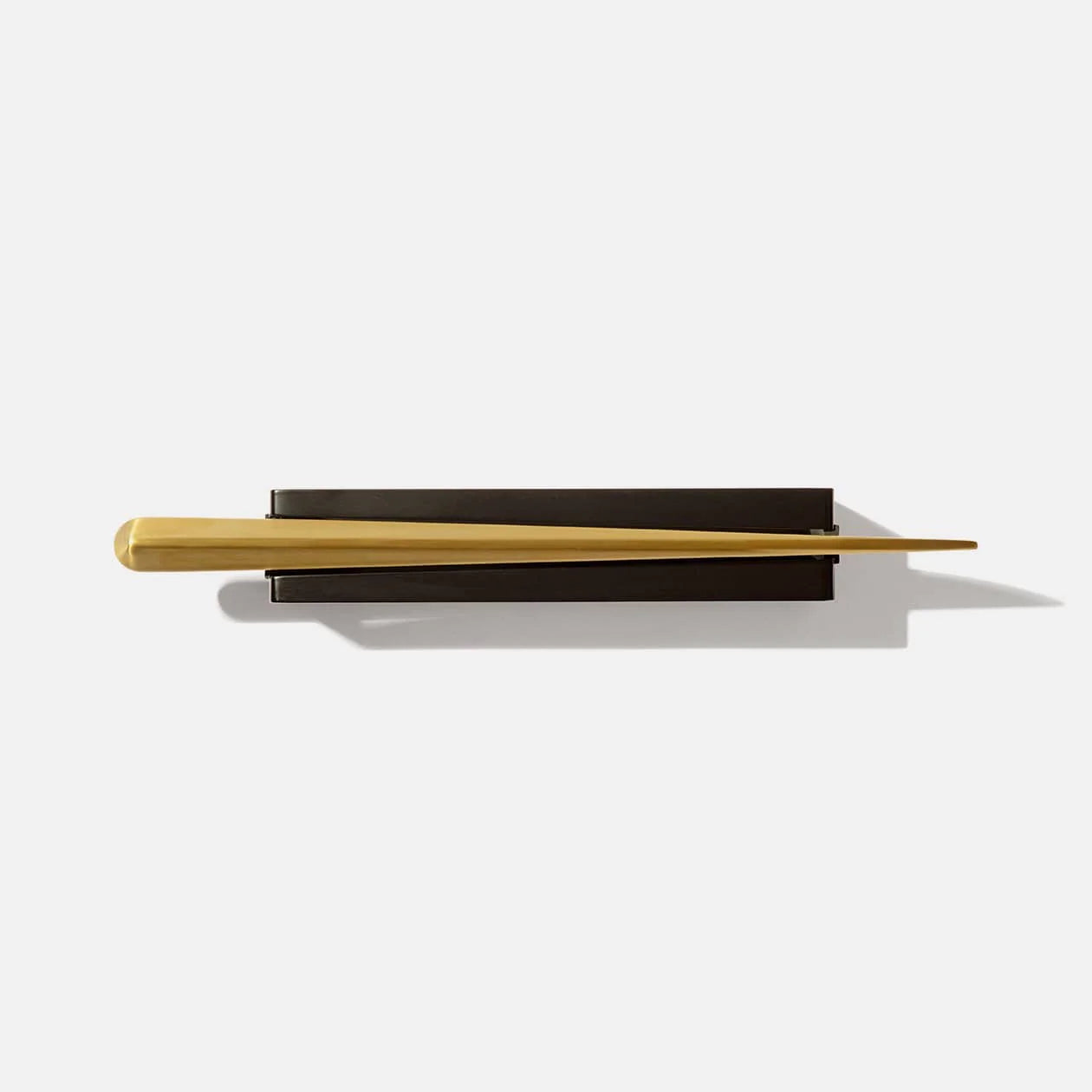 modern, brass colored champagne saber + black stand from above 
