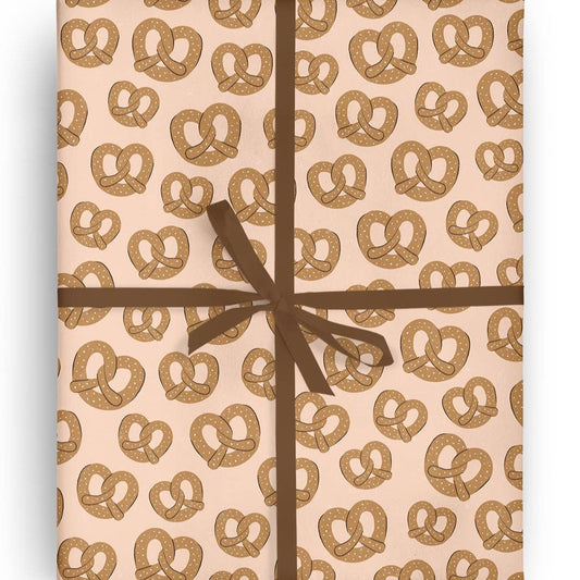 Sheet of gift wrap with salted soft pretzels on it 