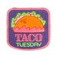 Primarily pink and purple iron patch that has an image of a hard shell taco and reads "Taco Tuesday"