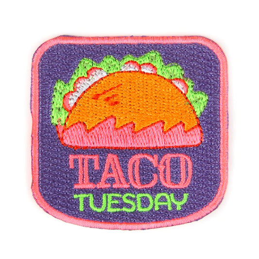 Primarily pink and purple iron patch that has an image of a hard shell taco and reads "Taco Tuesday"