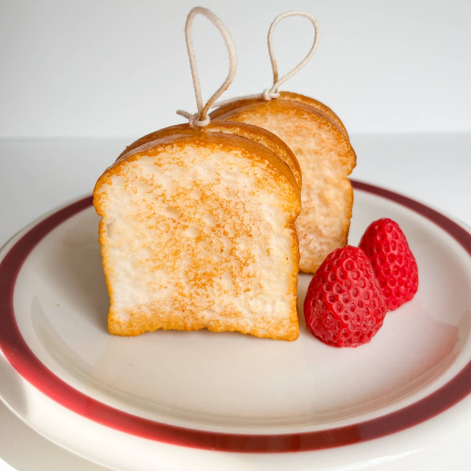 two candles that look and smell like real slices of toast