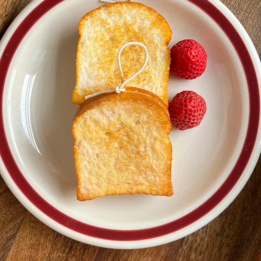 two candles that look and smell like real slices of toast 