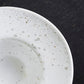 close-up of speckled white egg cup/saucer 