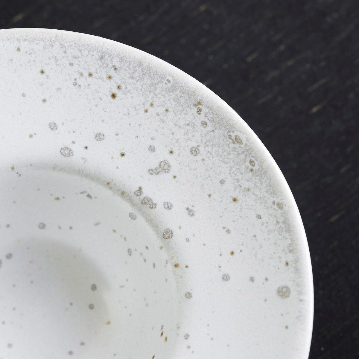 close-up of speckled white egg cup/saucer 